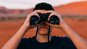 Stalking Defense Attorney in Tampa - Man looking through binoculars